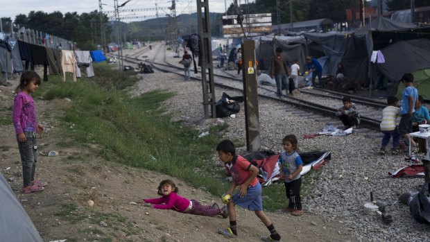 Children play at the makeshift refugee camp of the northern Greek border point of Idomeni on Sunday.