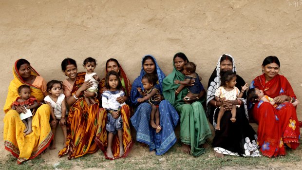 Mothers pose with their baby daughters in India where doctors are forfeiting professional fees to help change societal attitudes towards baby girls.