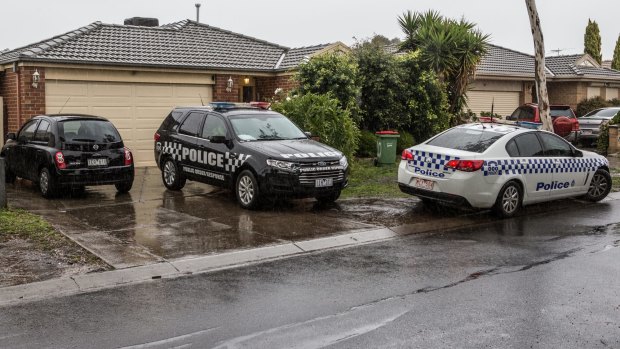 Police at the house where Khayre is believed to have lived with his mother and brothers.