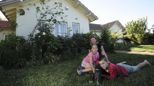 ‘NO ONE CAN SAVE IT NOW’: Fluffy homeowner Karen with her children Scarlett, 10 and Daniel, 12, and the family dog Gary outside their heritage-listed home.