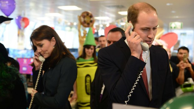 Prince William and his wife Catherine, Duchess of Cambridge, man the phones at ICAP's Charity Day.
