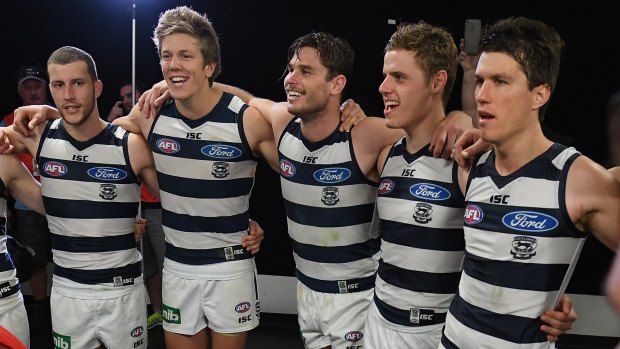 Purring along nicely: Cats players sing the team song after beating the Lions.