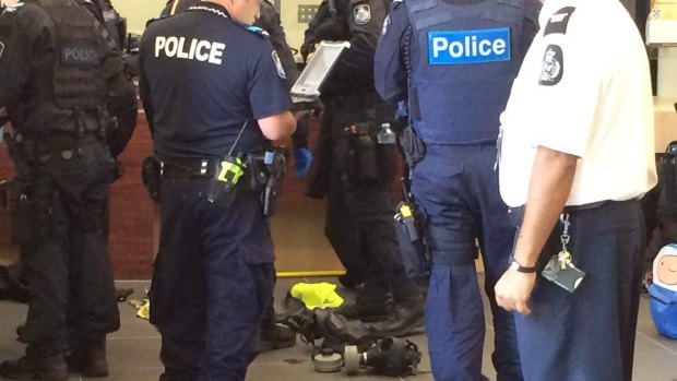 Two women are brought into custody at Brisbane's Roma Street police headquarters after allegedly being found with a gas mask and a knife at a G20 protest.