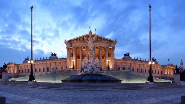 Paroramic view of the Parliament on Ringstrasse at blue hour.