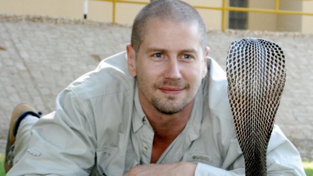 Venom expert Bryan Fry with a black cobra in Pakistan.