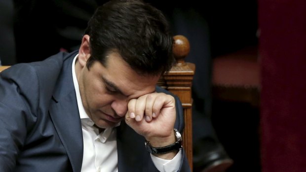 Greek Prime Minister Alexis Tsipras reacts during a parliamentary session in Athens.