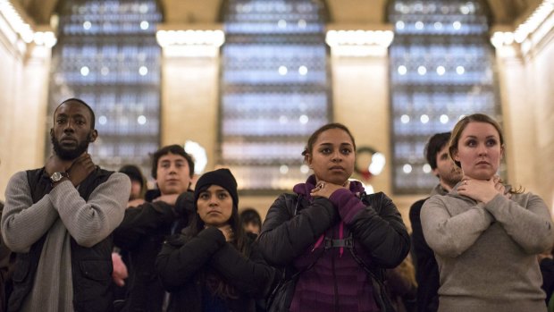 Protesters observe a moment of silence in a chokehold gesture at a protest in New York last year. 