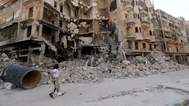 Syria's conflict has left vast damage: A man walks with the aid of a crutch past damaged buildings in the old city of Aleppo in recent days.