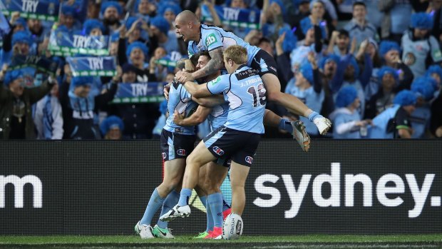 Mitch invasion: The Blues celebrate Mitchell Pearce's try.