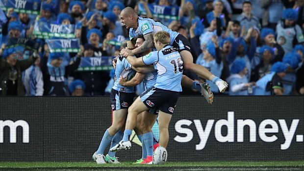 Mitch invasion: The Blues celebrate Mitchell Pearce's try.