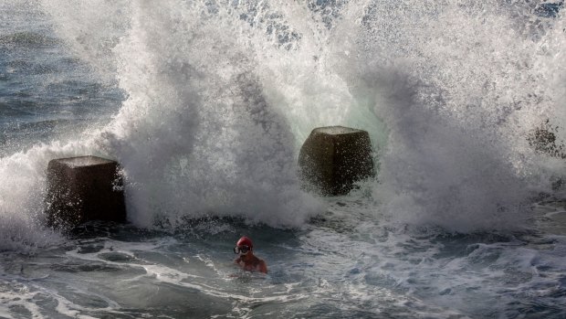 Rough seas pummel swimmers at Coogee Beach on Sunday.