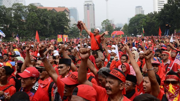 Pro-government 'red shirt' protestors shout slogans during a pro-government demonstration in Kuala Lumpur, Malaysia on Wednesday.