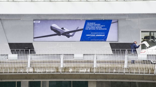 A defence industry advertising poster at Canberra Airport.
