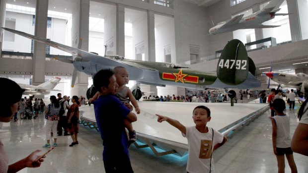 Visitors attend a museum exhibition in Beijing marking the 90th anniversary of the founding of the PLA.