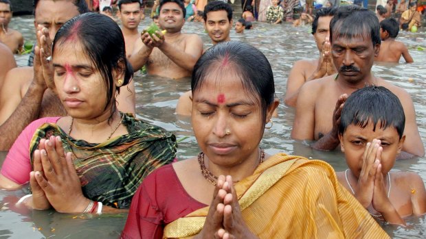 Hindu devotees worship in the River Brahmaputra in 2004. 
