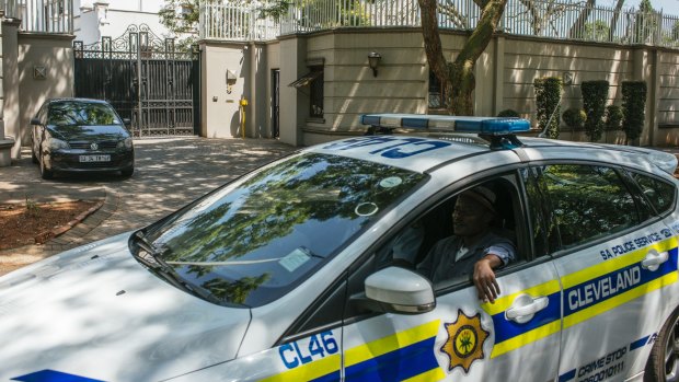 A police car patrols outside the residence of the Gupta family in Saxonworld, Johannesburg, South Africa, on Wednesday.