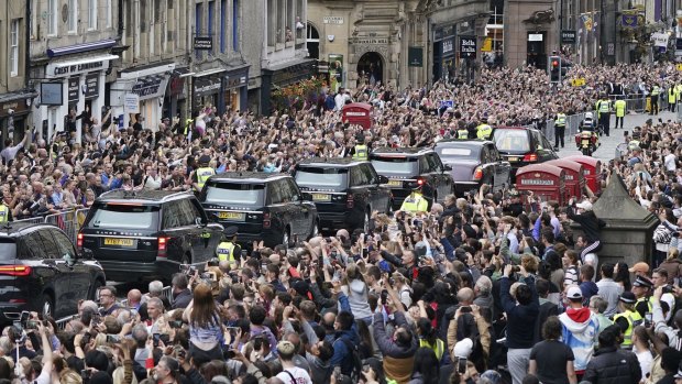 Crowds watch as the hearse carrying the coffin of Queen Elizabeth II makes its way to the Palace of Holyroodhouse in Edinburgh