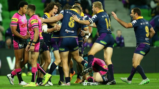 Running riot: Cooper Cronk celebrates with Storm teammates after crossing the line against the Penrith Panthers at AAMI Park.