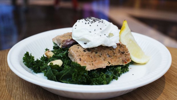 Sea salad: marinated wood-smoked salmon tossed with kale, quinoa, chia seeds, almonds, olive oil, garlic and  lemon topped with a poached egg.