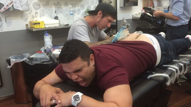 Mix94.5 presenter Pete Curulli takes his bet punishment and gets Fyfe tatooed on his bottom