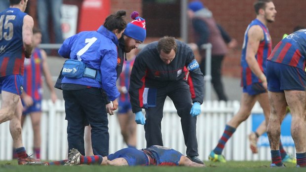 Injury worries: Port Melbourne staff attend to Nathan Batsanis.