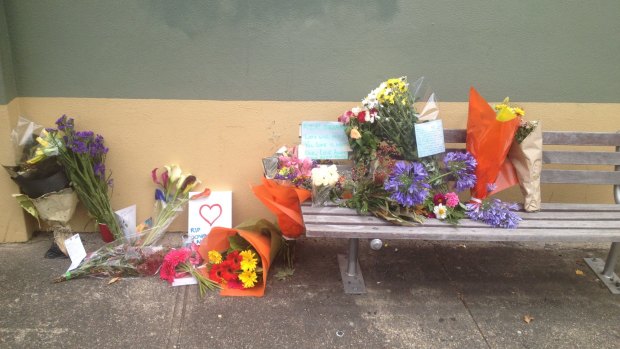 Students from Strathfield South Public School left flowers and notes at the bus stop where teacher Brian Liston died.