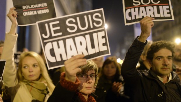 People in Spain join a demonstration in solidarity for the slain Charlie Hebdo journalists outside the French Consulate in Barcelona.