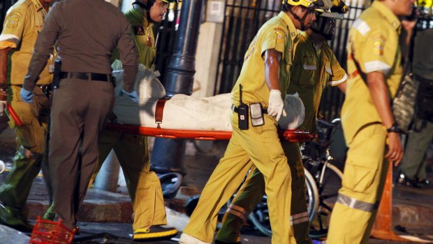 Rescue workers carry the body of a victim from the Erawan shrine.