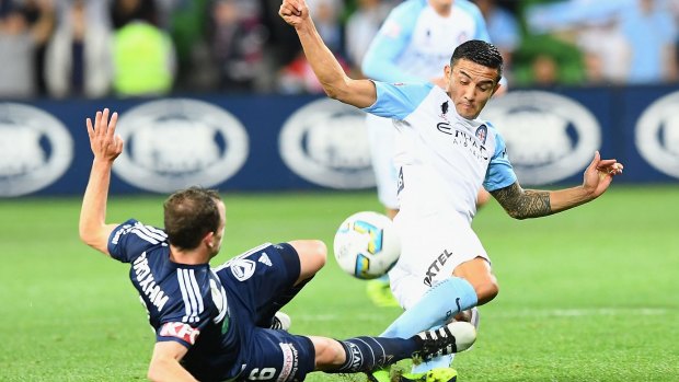 Victory’s Leigh Broxham and Tim Cahill of City compete for the ball in their FFA Cup semi-final match on Tuesday night at AAMI Park. 