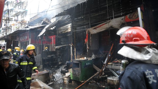 Firemen work to put out a fire following an explosion in a restaurant in Wuhu city on Saturday.