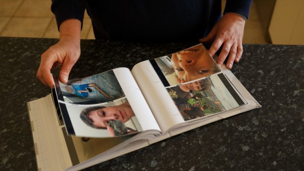 Michelle Degenhardt of Soldiers Point is pushing for a coronial inquest into the death of her son Luca Raso, 13. Luca died of peritonitis as a result of appendicitis which his GP failed to identify. Pic shows Michelle loking through an album of pictures of Luca, in the kitchen of her home. Picture: Max Mason-Hubers MMH