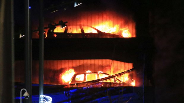 Vehicles burn during a blaze at a multi-storey car park at the Echo Arena on the waterfront in Liverpool.