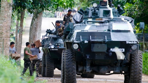 Troops load ammunition and supplies as a convoy of APCs head to Marawi  on Thursday, three days after Islamist militants laid siege to the provincial capital.