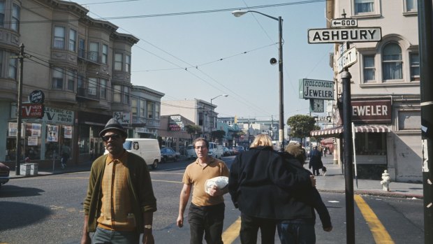 Pedestrians walking along a sidewalk by the intersection of Haight and Ashbury streets in the Haight-Ashbury district of San Francisco during the 'Summer of Love' in 1967. 