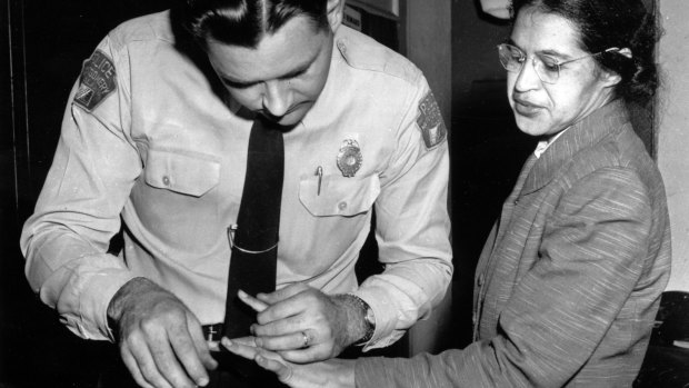 A police officer takes Rosa Parks finger prints in February 1956, two months after she refused to give up her seat on a bus for a white passenger.