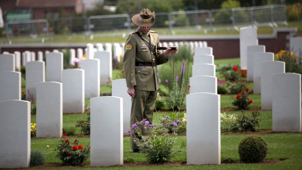 A lone Australian soldier pays his respects at Fromelles.