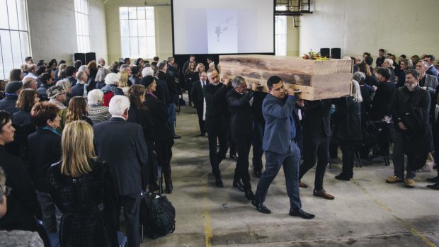 Pallbearers carry the bespoke coffin of designer Robert Foster at his funeral at the Fitters Workshop. 


