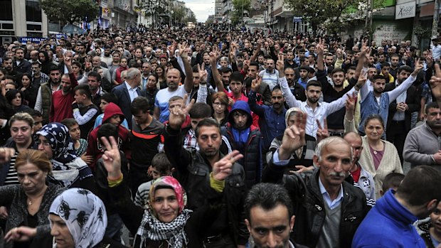 People march in protest at an explosion that killed scores of people in Ankara.