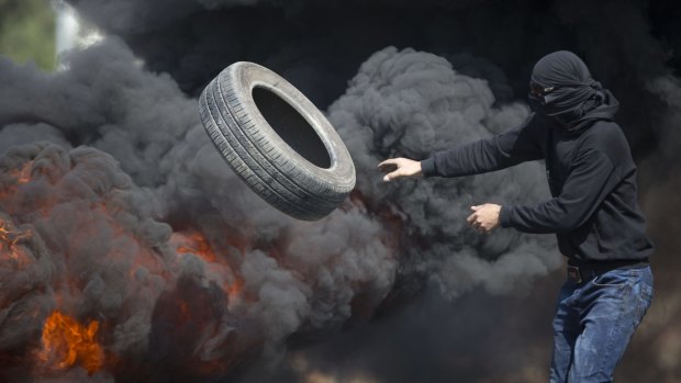 Palestinians burn tires during clashes with Israeli troops near Ramallah, West Bank.