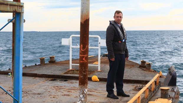 Environment Minister Steven Miles on board the MDT 7 barge, prior to its sinking.