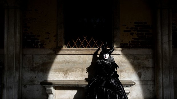 A woman in full costume for Venice Carnival, which was on Sunday cancelled due to the coronavirus outbreak.