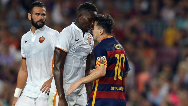 Meeting of the minds: Barcelona's Lionel Messi, right, and Roma's Mapou Yanga-Mbiwa.