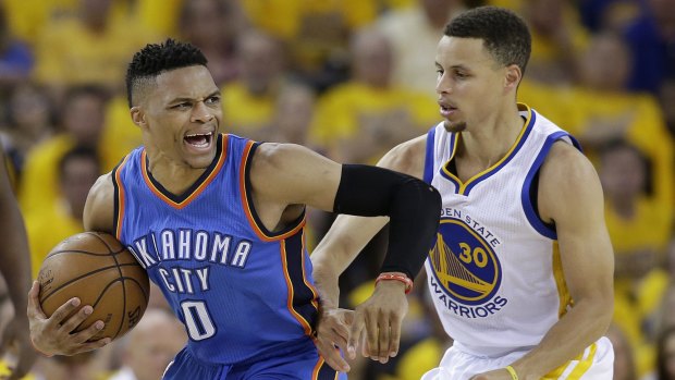 Heavily guarded: Oklahoma City Thunder's Russell Westbrook reacts as he is defended by Golden State Warriors rival Steph Curry.