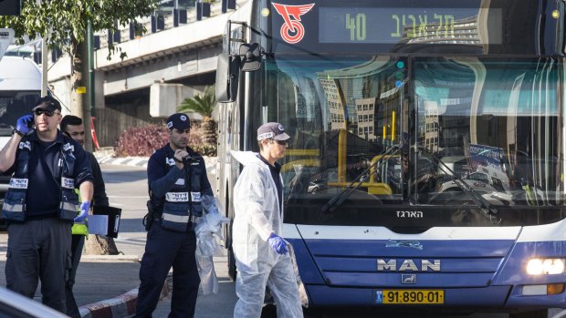 Israeli forensics examine the scene of an attack after a Palestinian man stabbed at least 12 people on a Tel Aviv bus on Wednesday.