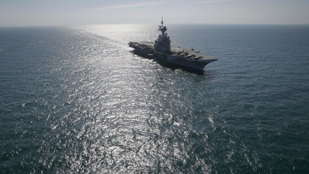 France's flagship Charles de Gaulle aircraft carrier navigates in the Persain Gulf as part of the US- led coalition against the Islamic State group, conducting airstrikes in Syria earlier this month.
