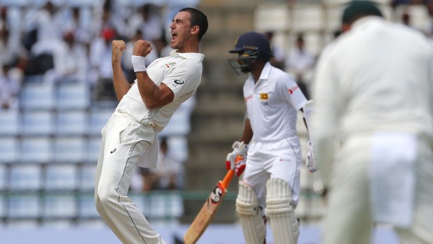 Mitchell Starc celebrates the wicket of Dimuth Karunaratne early on day one at Pallekele.