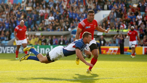 Namibia's Johan Tromp scores one of his side's three tries against Tonga.