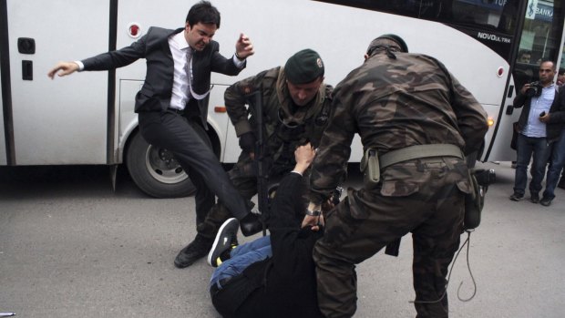Yusuf Yerkel, an adviser to Turkish Prime Minister Recep Tayyip Erdogan, kicks a protesting miner during Mr Erdogan's visit to Soma in the wake of the disaster.