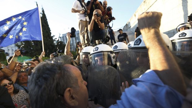 Pro-EU protesters scuffle with riot police outside the parliament building during a rally calling on the government to clinch a deal with its international creditors and secure Greece's future in the Eurozone, in Athens, Greece.