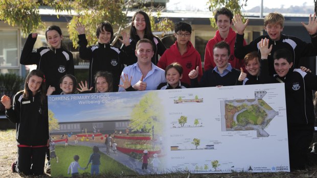 University of Canberra students Luke Duggan (centre front) and Chris Norris (third from right) with Torrens Primary School students at the launch of a new playground design.